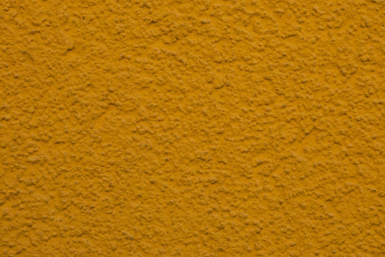 The Art of Drawing Readers In: Your attractive post title goes here Close-up of a textured yellow plaster wall, ideal for backgrounds or design projects.